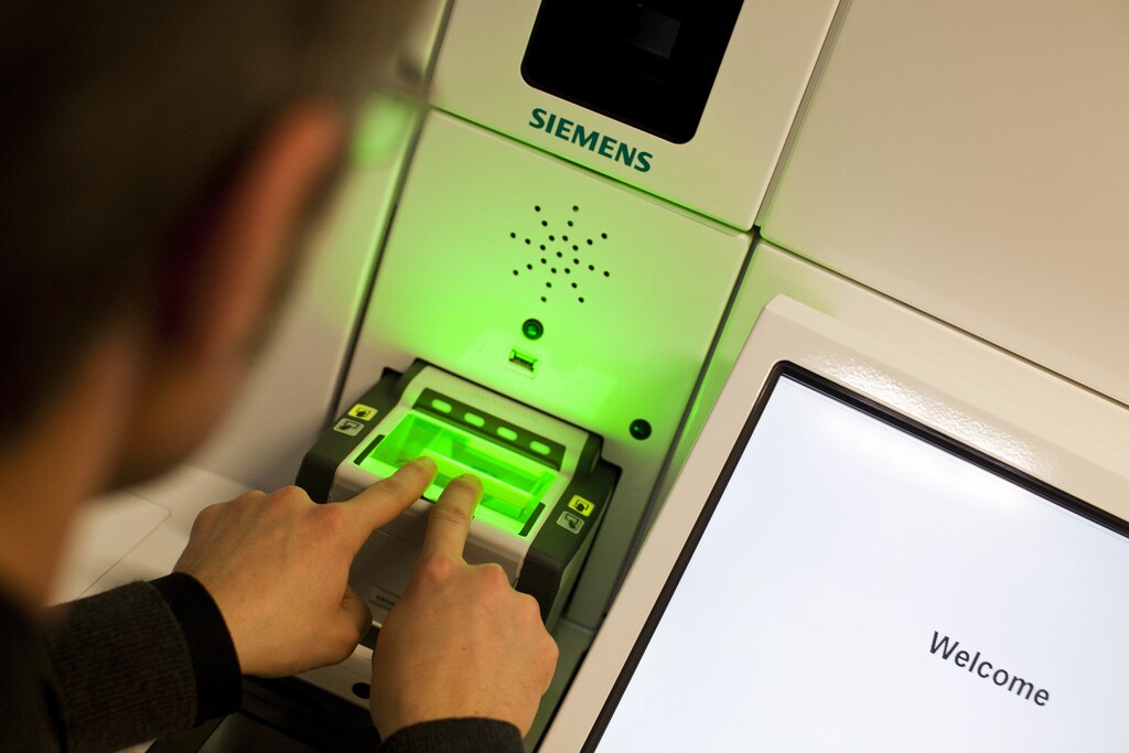 A man demonstrates the issuing of the new Swiss biometric passport at the Office of Passport Services in Zurich, January 26, 2010.