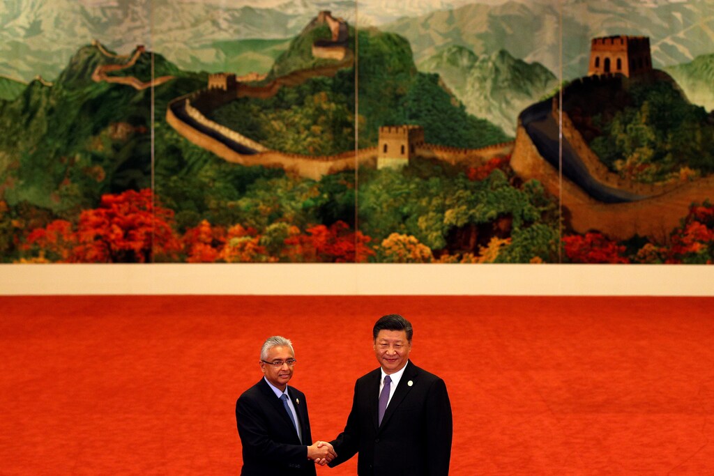 Mauritius Prime Minister Pravind Kumar Jugnauth, left, shakes hands with Chinese President Xi Jinping during the Forum on China-Africa Cooperation held at the Great Hall of the People in Beijing September 3, 2018. Andy Wong/POOL Via REUTERS - RC1E7ADD04C0