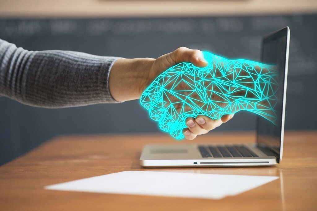 A human hand and an illustration of a virtual hand grip each other