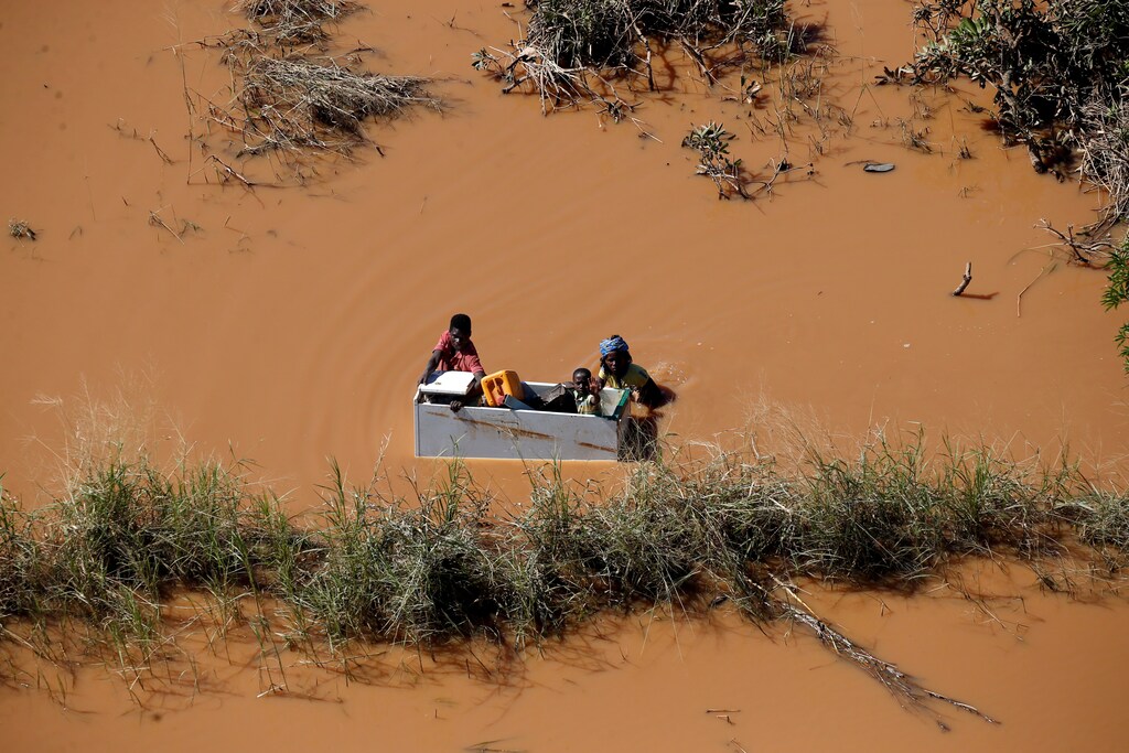 A child is transported on a fridge during floods after Cyclone Idai, in Buzi, outside Beira, Mozambique, March 21, 2019