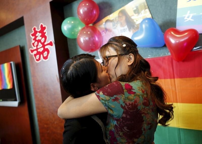 Li Tingting (L) and Teresa kiss at their wedding reception in Beijing, China July 2, 2015. Li, a 25-year-old prominent women's rights activist who was released from detention in April, held the wedding ceremony with her partner Teresa on Thursday and announced their marriage in an effort to push for LGBT (lesbian, gay, bisexual, and transgender) rights in China.