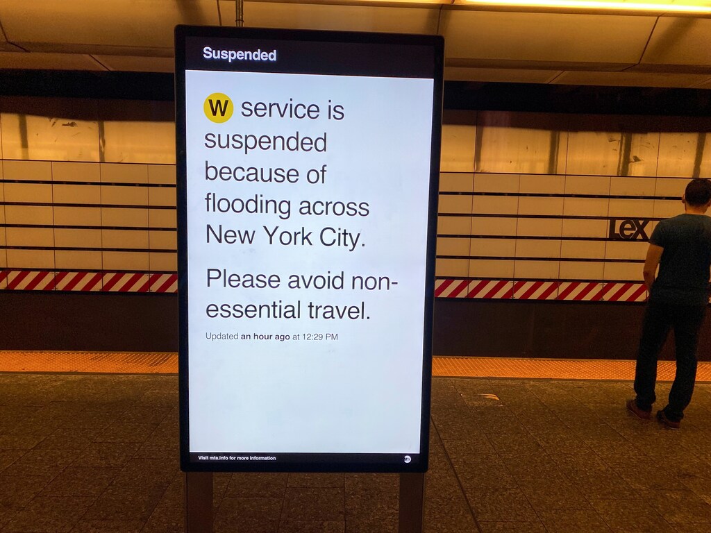a subway service notice explains to travellers that the service is suspended due to flooding