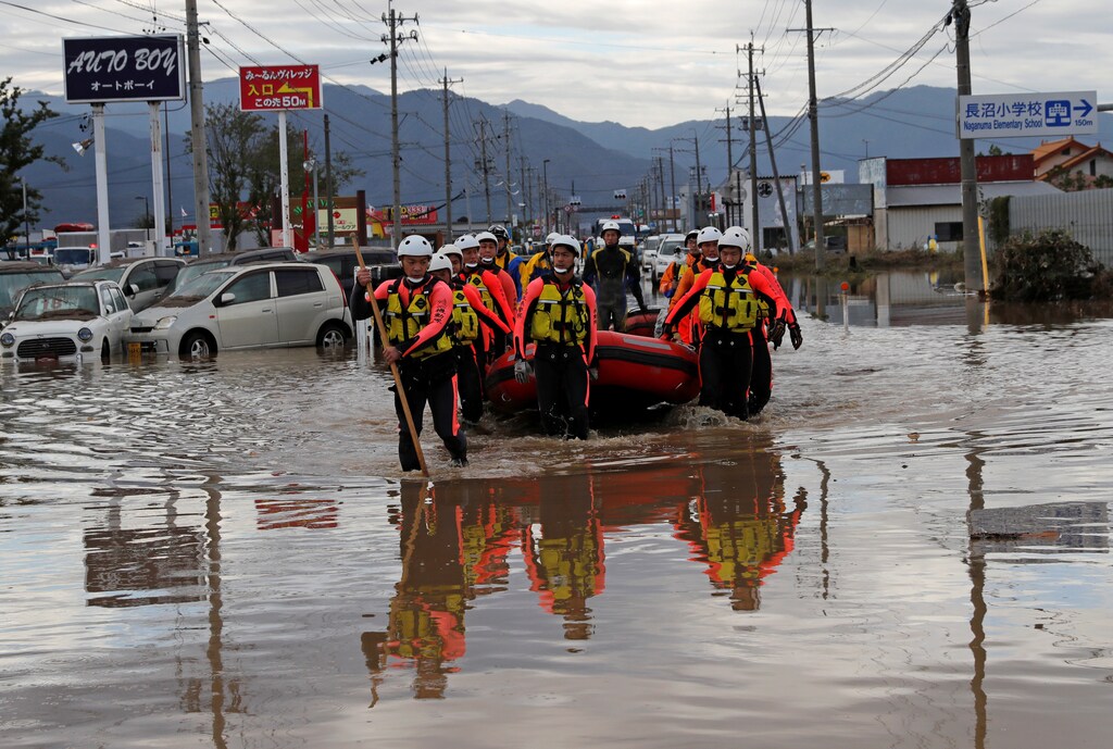 Rescue workers search a flooded area in the aftermath of Typhoon Hagibis, which caused severe floods at the Chikuma River in Nagano Prefecture, Japan, October 14, 2019. REUTERS/Kim Kyung-Hoon - RC18E0EADB00