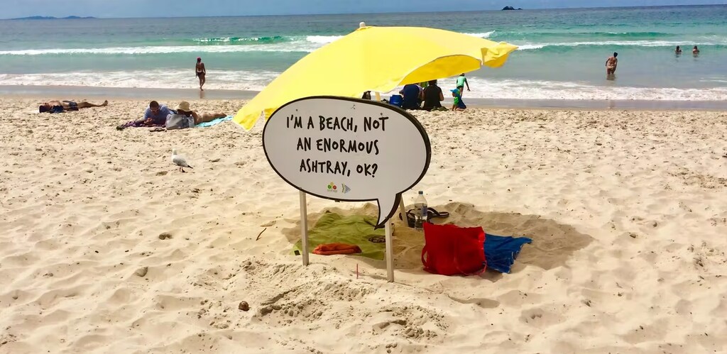 A sign on a beach that says "I'm a beach, not an enormous ashtray, ok?"