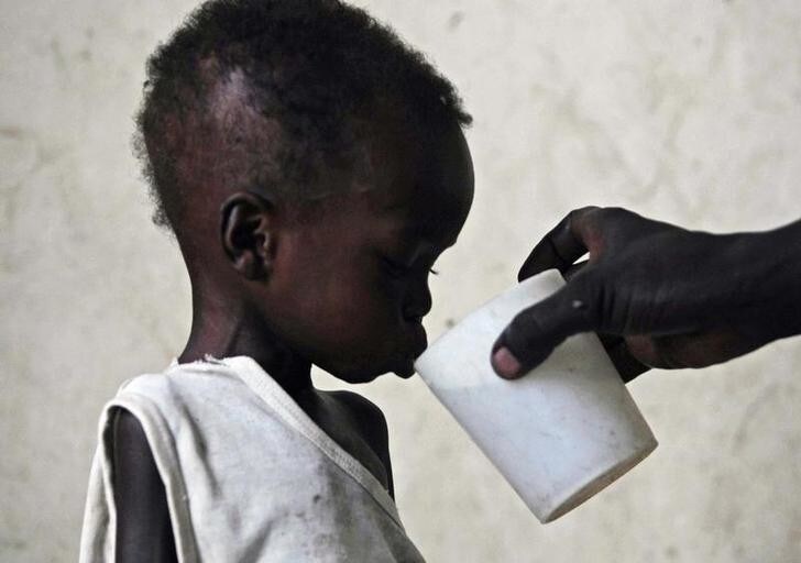 Malnourished two-year-old Dhoah Thoan is fed at a hospital ward in Akobo in southeastern Sudan's Jonglei state April 10, 2010. The UN recently called Akobo "the hungriest place on earth" after years of failed rains and tribal clashes that killed more than 2,000 people during the past year. REUTERS/Mohamed Dahir (SUDAN - Tags: HEALTH SOCIETY ELECTIONS POLITICS IMAGES OF THE DAY)