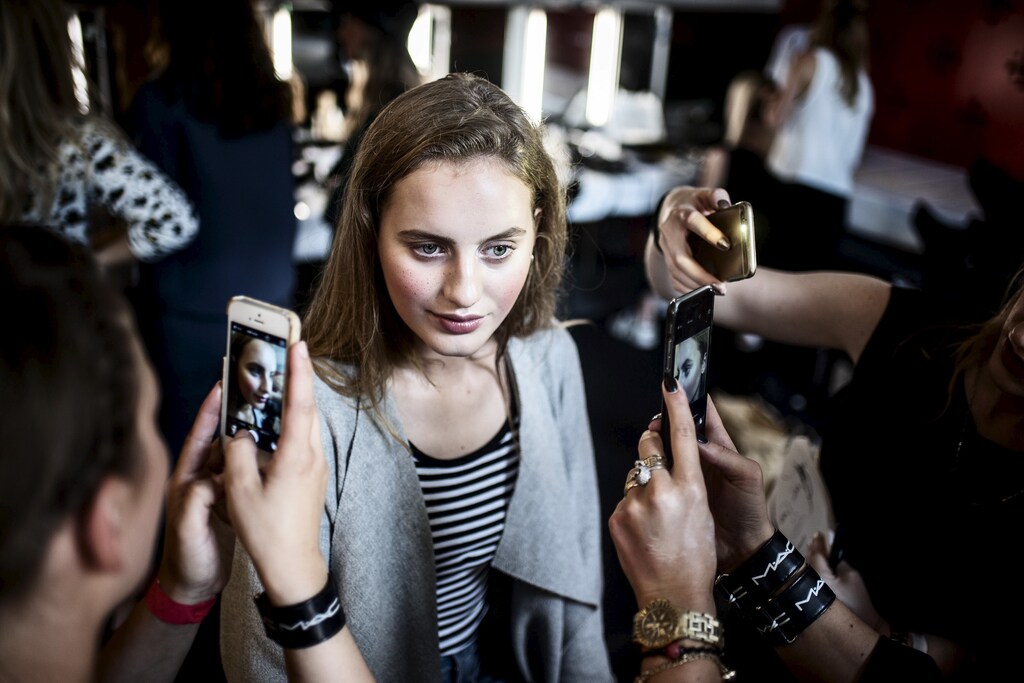 A model poses for pictures ahead of the fashion show by Danish fashion designer Nicholas Nybro during Copenhagen Fashion Week at the Copenhagen City Hall, August 7, 2015.