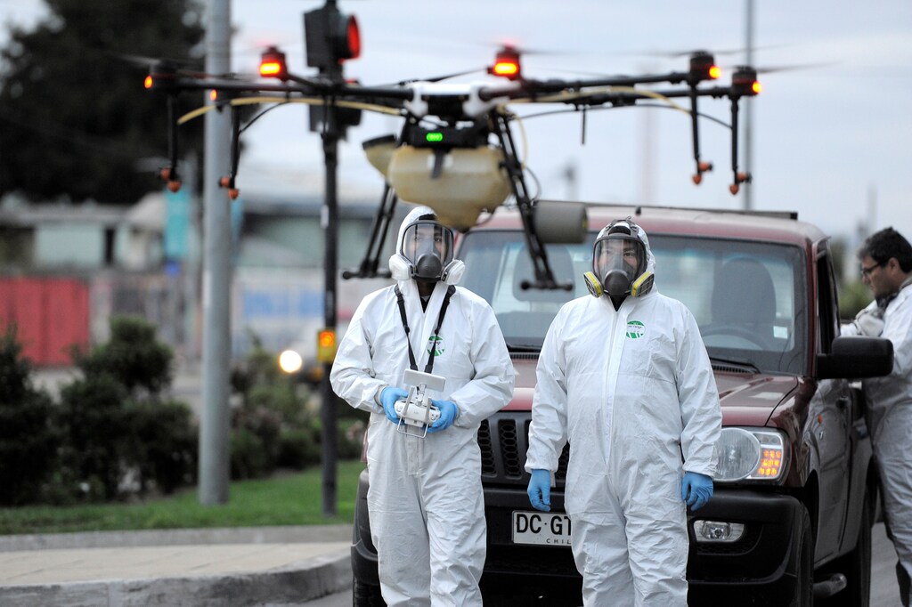 Local community workers use a drone loaded with disinfectant to released on streets during the coronavirus disease (COVID-19) outbreak in Talcahuano, Chile March 21, 2020. REUTERS/Jose Luis Saavedra - RC2JOF9IBZQT