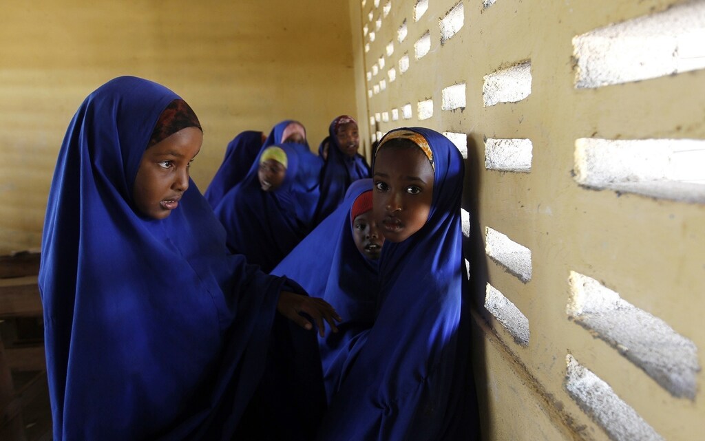 Girls stand inside their classroom at a primary school in Dobley town, 10 km (6 miles) from the Kenya-Somalia border, February 21, 2012. Kenyan troops rolled tanks and troops across its arid frontier into lawless Somalia, in another campaign to stamp out a rag-tag militia of Islamist rebels that has stoked terror throughout the region with threats of strikes.