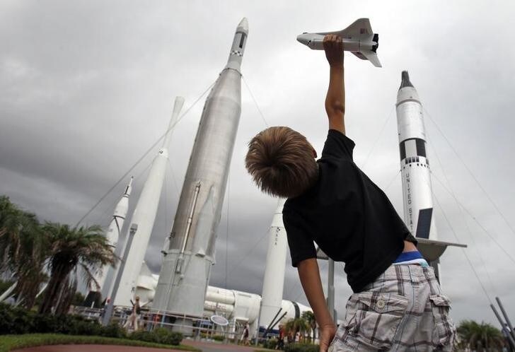 Freddy Porter, 5, of Raleigh N.C. plays with a toy space shuttle in the Rocket Garden of the Kennedy Space Center Visitor Complex near Cape Canaveral, Florida July 7, 2011. Porter, visiting with family was hoping to witness his first launch as space shuttle Atlantis, carrying a crew of four and food and other supplies critical for the International Space Station, is set to vault into orbit on Friday on the final flight in the 30-year U.S. shuttle program. REUTERS/Hans Deryk (UNITED STATES - Tags: SCI TECH IMAGES OF THE DAY)