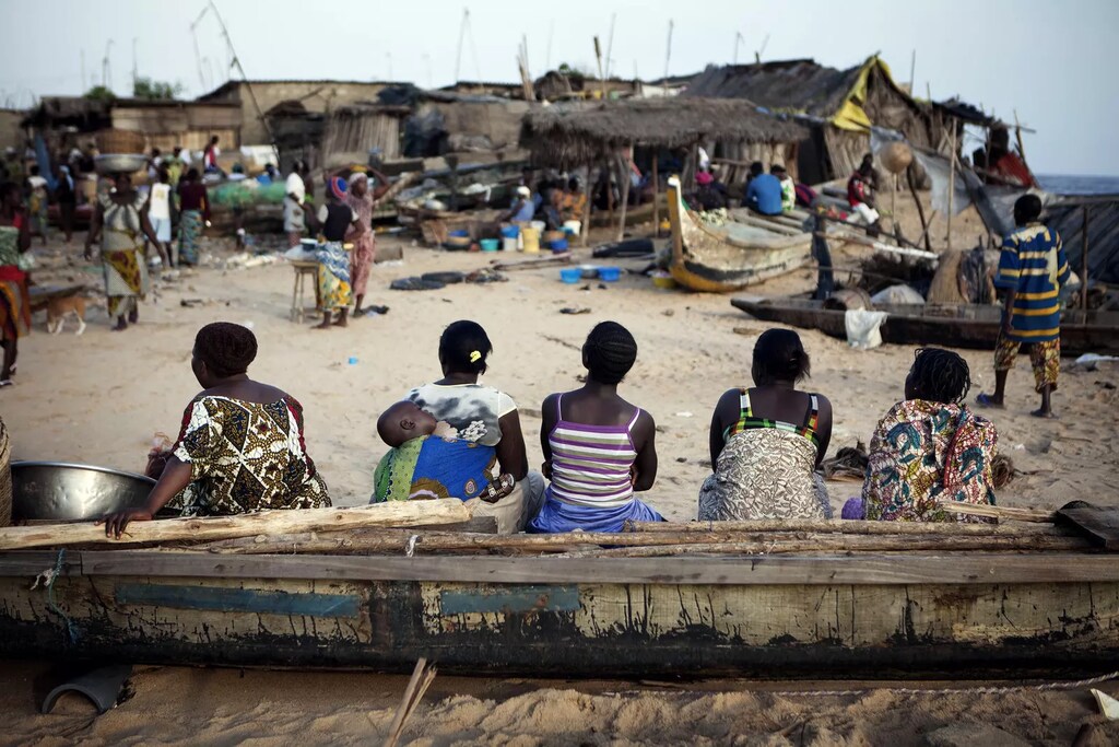 Women sit on a fishing boat in the Akpakpa neighbourhood of Benin's capital Cotonou.