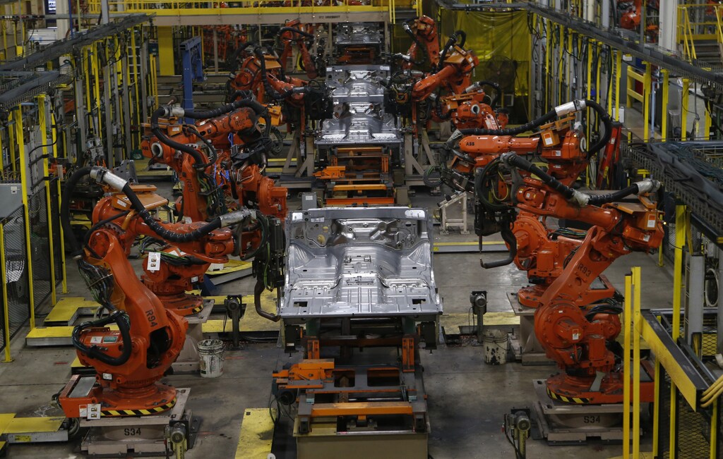 Robotic arms work on the underside chassis of 2014 Dodge Ram pickup trucks at Chrysler Group's Warren Assembly Plant in Warren, Michigan December 11, 2013. Chrysler Group LLC, which is owned by Fiat SpA, on January 29, 2014, said its revenue would rise 11 percent to about $80 billion in 2014. The American automaker that went through bankruptcy in 2009 and came out managed by Fiat, is now fully owned by the Italian company, which reported fourth-quarter earnings on Wednesday below expectations of analysts. Chrysler's fourth-quarter net income of $1.62 billion, up 329 percent from the previous year, included a $962 million non-cash tax benefit related to the release of a valuation allowances on deferred tax assets. Picture taken December 11, 2013. REUTERS/Rebecca Cook (UNITED STATES - Tags: TRANSPORT BUSINESS EMPLOYMENT) - GM1EA1T1SVA01