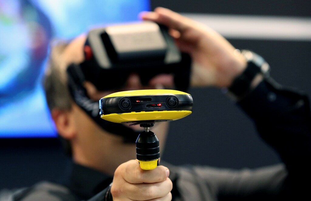 A journalist checks out the Vuze 3D 360 video camera at the Vuze booth on the Photokina, the world's largest fair for imaging in Cologne, Germany, September 20, 2016. REUTERS/Fabrizio Bensch - RTSOL6V