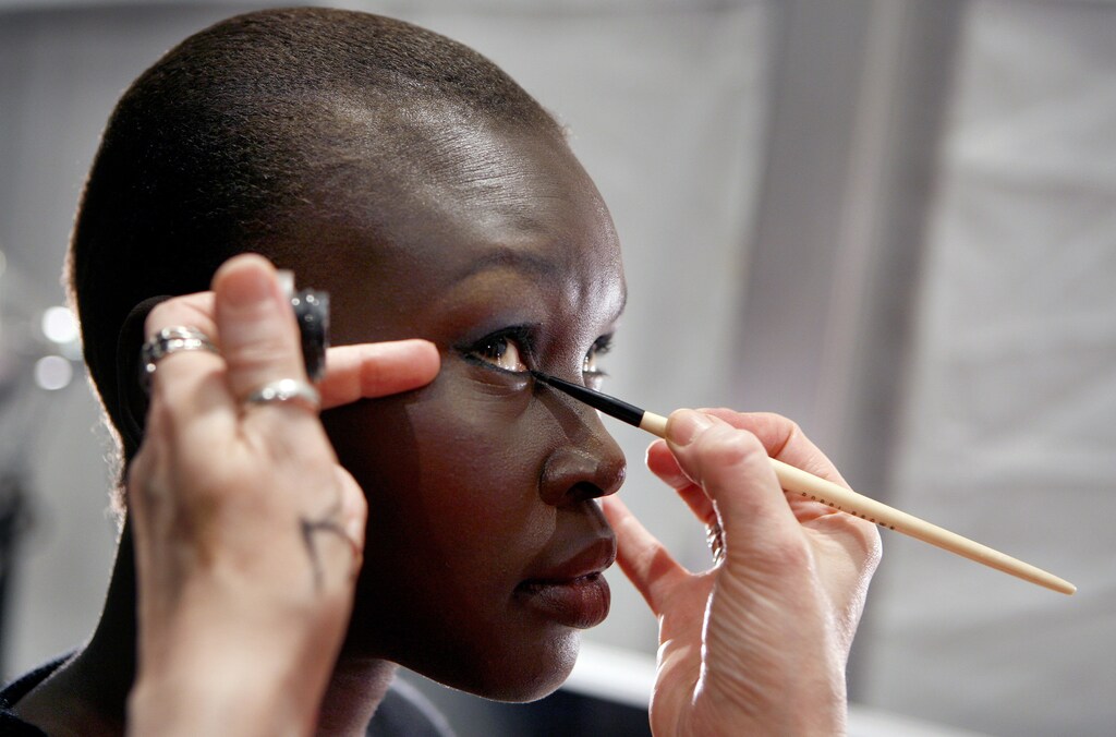 Model Alek Wek has make-up applied backstage of the Heart Truth Red Dress fashion show during New York Fashion Week February 2, 2007. The annual charity show features celebrity models and guest designers to raise awareness about women's heart disease. REUTERS/Lucas Jackson (UNITED STATES) - GM1DUNGYLQAA