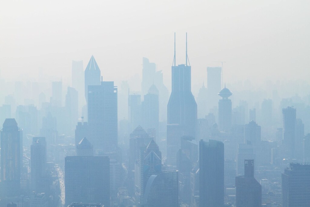 A city scape is shown clouded with excessive pollution in Shanghai, China, representing the need for clean air for all