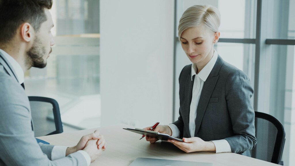Man and woman, job interview; AI skills are increasingly valuable to businesses looking for new hires.