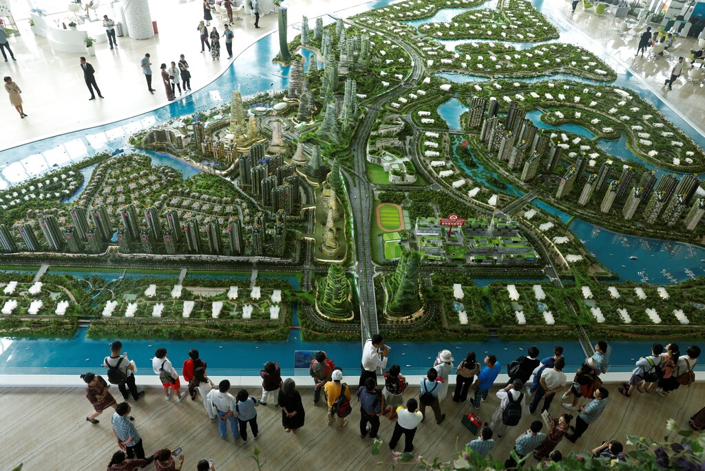 Prospective buyers look at a model of the development at the Country Gardens' Forest City showroom in Johor Bahru, Malaysia February 21, 2017. Picture taken February 21, 2017. REUTERS/Edgar Su TPX IMAGES OF THE DAY - RC1FB045E0E0