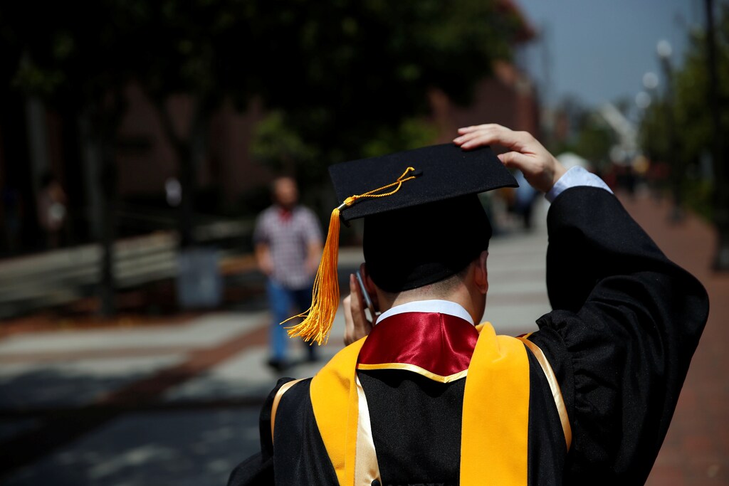 A graduate holds their mortarboard cap after a commencement ceremony at the University of Southern California (USC) in Los Angeles, California, U.S., May 12, 2017. REUTERS/Patrick T. Fallon - RTS16FCV