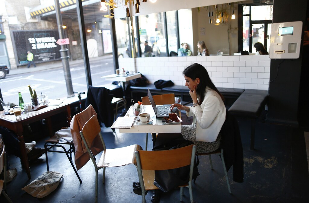 A customer sits near a Bitcoin machine at the Old Shoreditch Station Cafe and Bar in east London March 7, 2014.