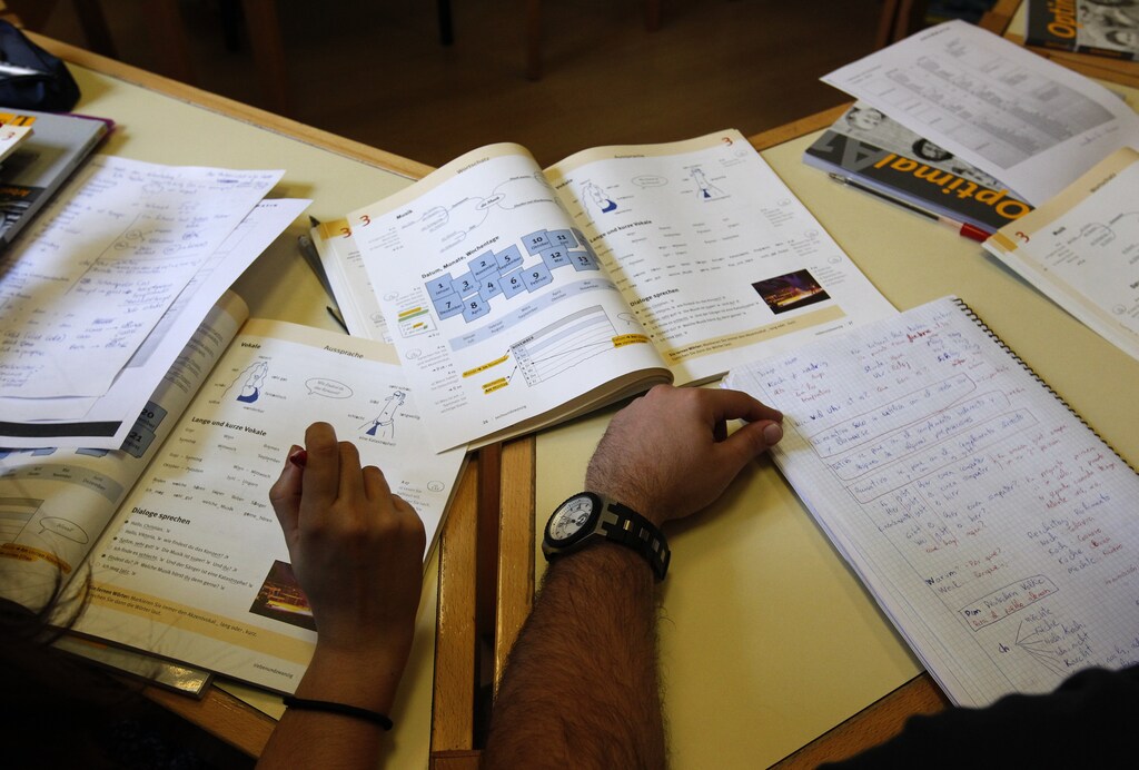 German text books are seen on a desk during a German language class for Spanish students at an academy in Madrid May 18, 2012. A European Union survey in 2005 found the majority of Spaniards had not learned a second language: even those who wanted to improve their language skills did not make German their top choice, but preferred English and French. After France and the United Kingdom, Germany was the third most popular destination in Europe for Spanish migrants in 2011. Picture taken May 18, 2012. To match Insight EUROPE/LABOUR REUTERS/Andrea Comas (SPAIN - Tags: EDUCATION SOCIETY) - GM1E85V19IW01