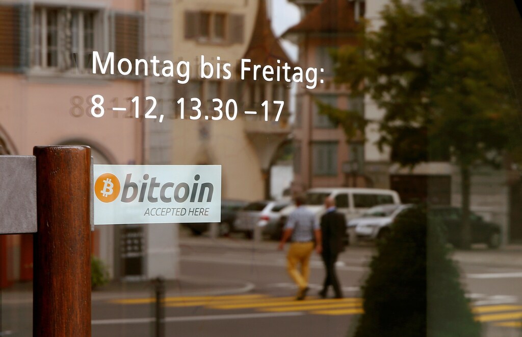 A sticker reading "Bitcoin accepted here" is placed at the entrance of the Stadthaus town hall in Zug, Switzerland, August 30, 2016. Picture taken August 30, 2016. REUTERS/Arnd Wiegmann - RTX2OLTZ