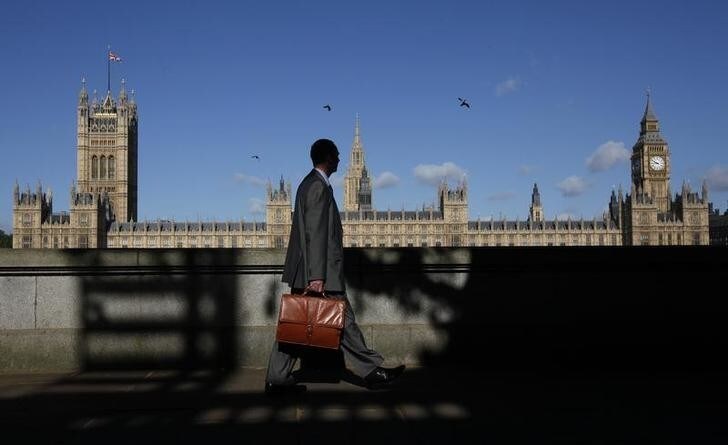 A man walks past the Houses of Parliament in London May 10, 2011. The Palace of Westminster, inside the Houses of Parliament, could host wedding receptions under plans to cut Parliament's subsidised catering bill, local media report. REUTERS/Suzanne Plunkett (BRITAIN - Tags: TRAVEL CITYSCAPE POLITICS)