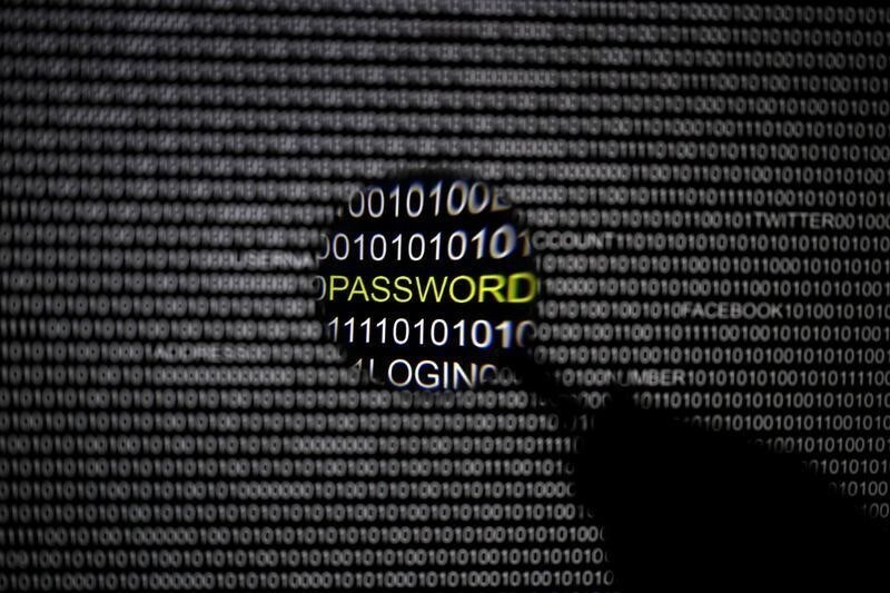 A magnifying glass is held in front of a computer screen in this picture illustration taken in Berlin May 21, 2013. The Financial Times' website and Twitter feeds were hacked May 17, 2013, renewing questions about whether the popular social media service has done enough to tighten security as cyber-attacks on the news media intensify. The attack is the latest in which hackers commandeered the Twitter account of a prominent news organization to push their agenda. Twitter's 200 million users worldwide send out more than 400 million tweets a day, making it a potent distributor of news. REUTERS/Pawel Kopczynski (GERMANY - Tags: CRIME LAW SCIENCE TECHNOLOGY) - BM2E95L11MP01