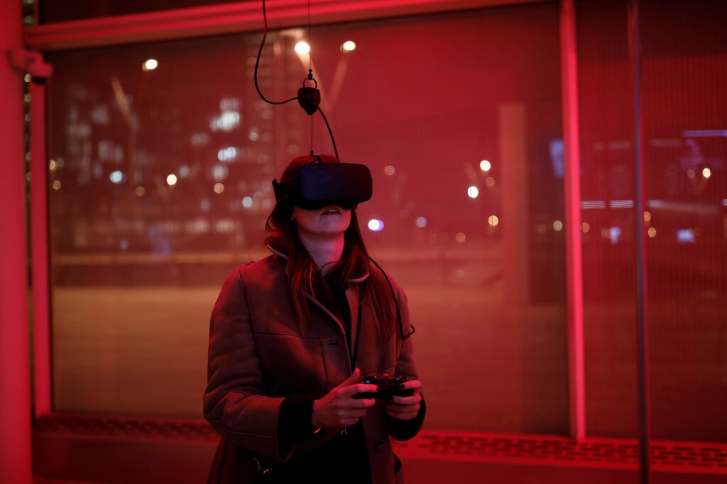 A woman plays a video game with the Oculus Rift VR in Paris, France, December 2016.
