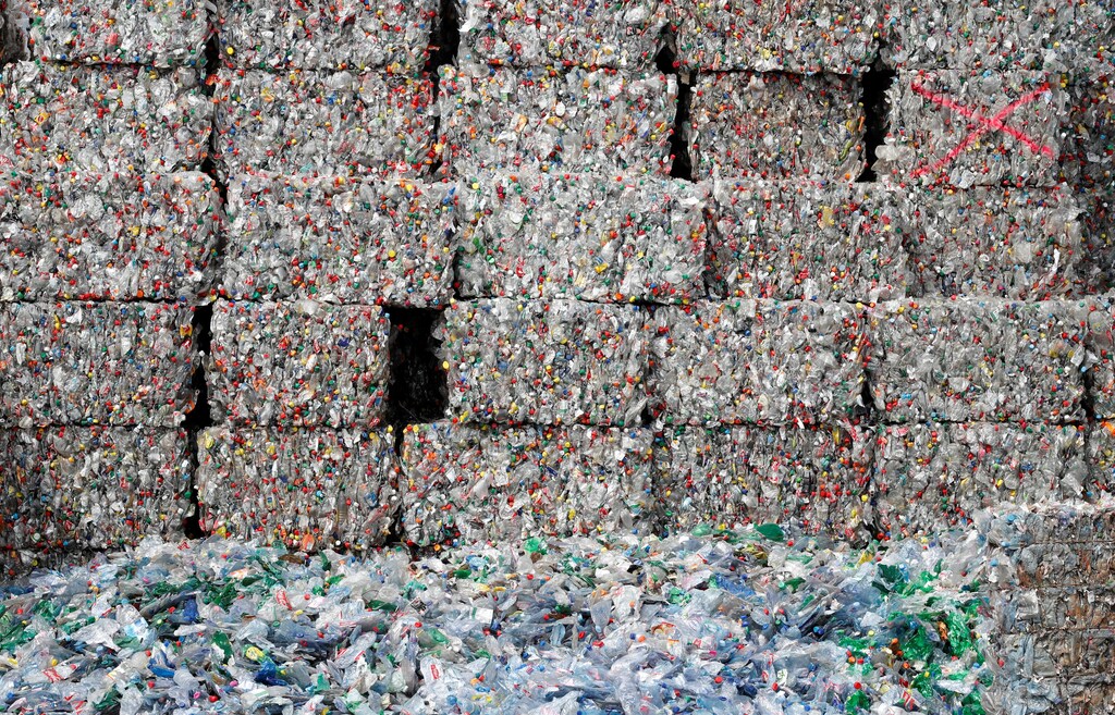 Bundles of pressed bottles made from PET (polyethylene terephthalate) plastic are stored at Poly Recycling AG company in Bilten, Switzerland April 3, 2019. REUTERS/Arnd Wiegmann - RC11F0072980