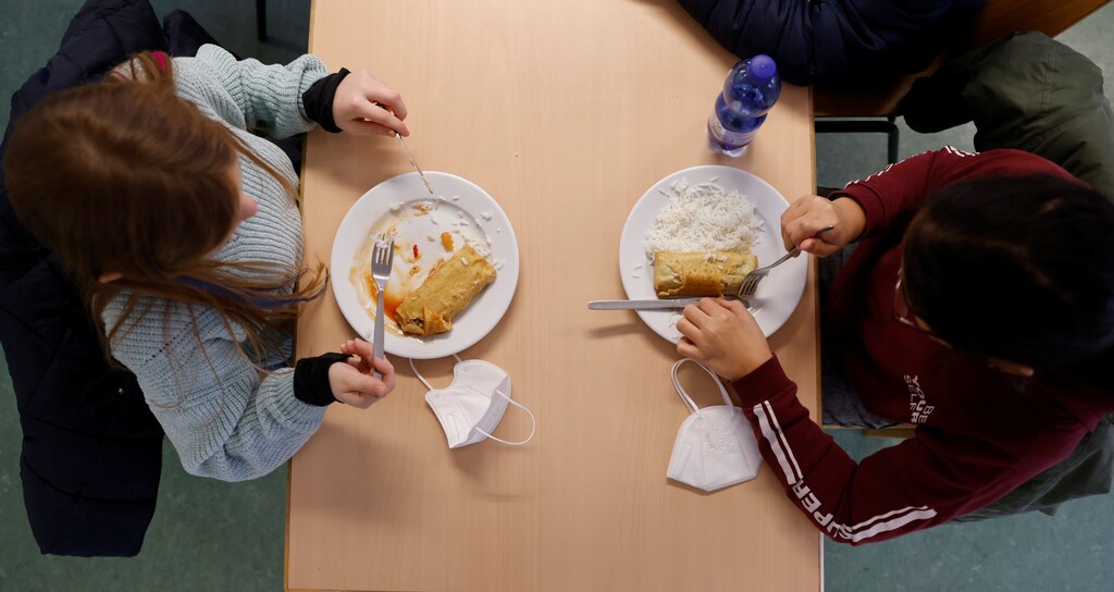 Schoolchildren eat their lunch at the canteen