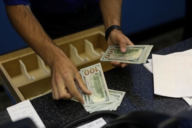 A teller is counting money before betting opens to the public at Monmouth Park Sports Book by William Hill, ahead of the opening of the first day of legal betting on sports in Oceanport, New Jersey, U.S., June 14, 2018. REUTERS/Mike Segar