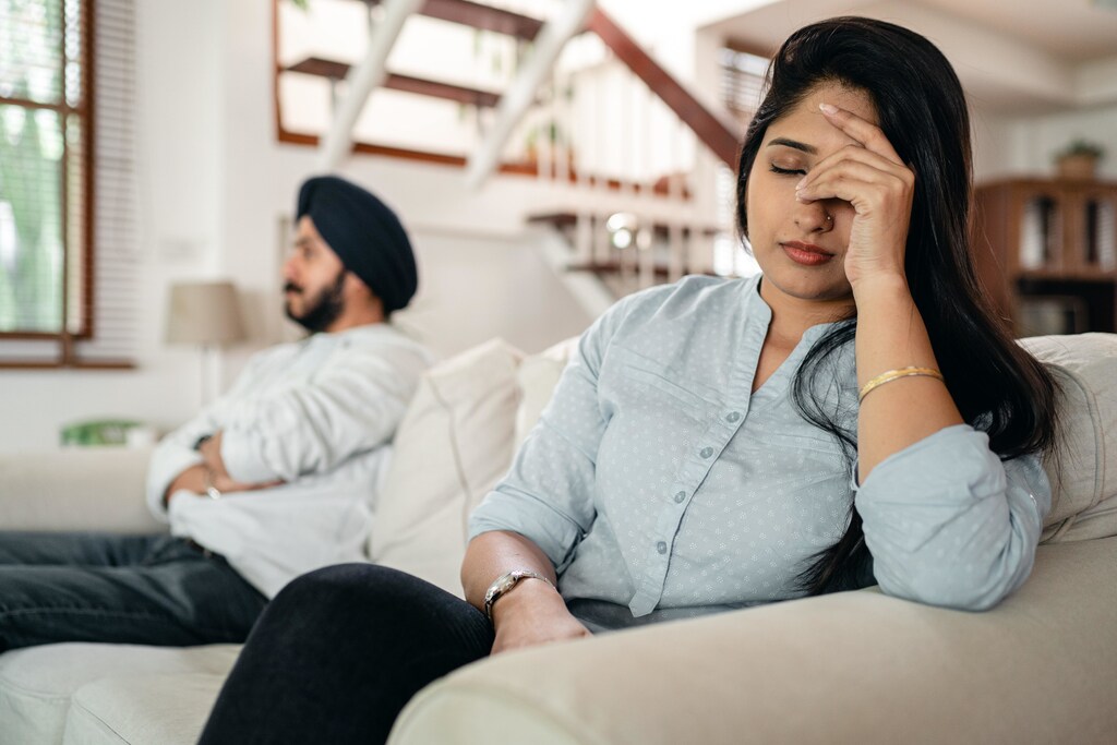 Two people sat on a sofa after a conflict