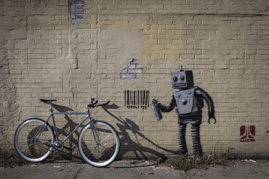 A bike sits next to the newest art installation by British artist Banksy, a robot and a barcode, in the Coney Island area of New York City, October 28, 2013.