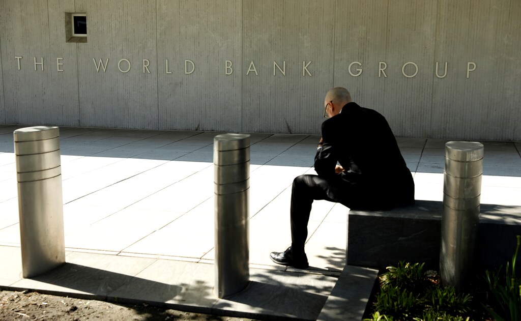 A man takes a break in front of the World Bank in Washington, U.S., May 7, 2018: Investments in health, energy, water, education, and infrastructure are productive foundations of economic growth