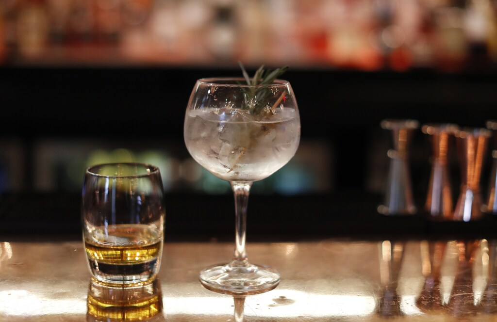 A Gin Cocktail and glass of whisky sit side by side on the bar at the Angels Share, Edinburgh, Scotland, Britain December 14, 2016. REUTERS/Russell Cheyne - LR1ECCE17QU8Z