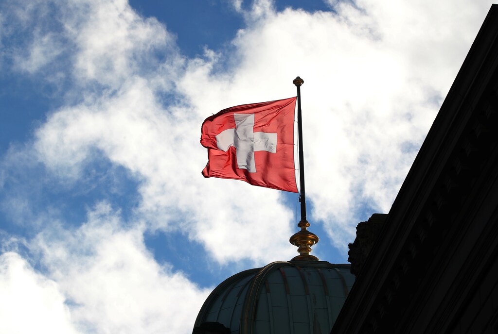 A Swiss flag is pictured on the Federal Palace (Bundeshaus) in Bern, Switzerland December 7, 2018. Picture taken December 7, 2018. REUTERS/Denis Balibouse - RC1F1BC7CB70