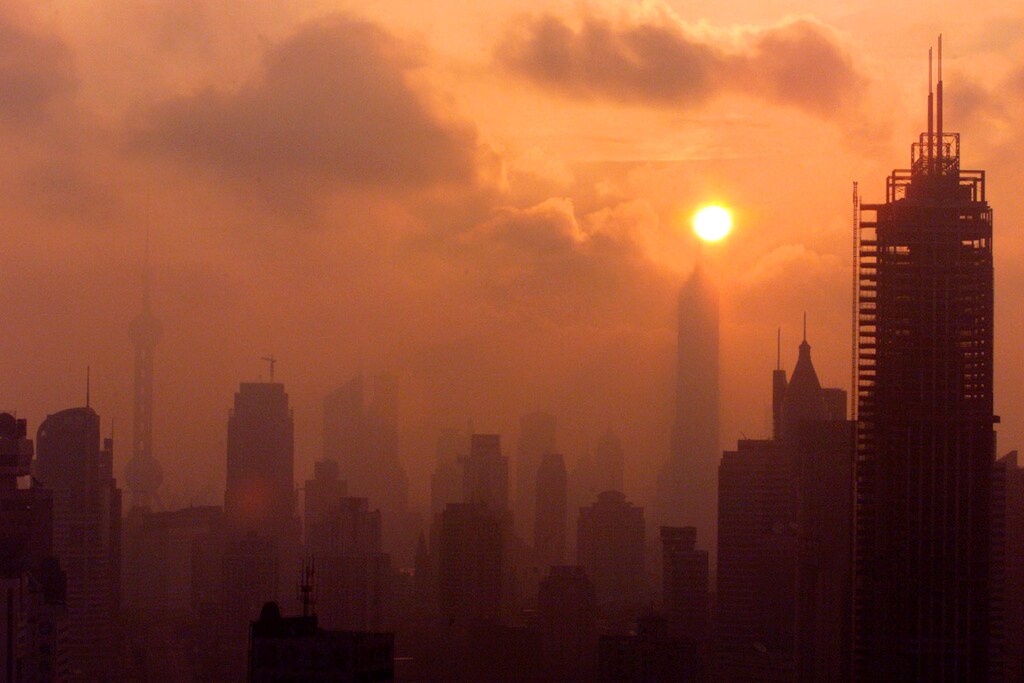 The Shanghai skyline is silhouetted as the sun rises over China's business capital July 24, 2001
