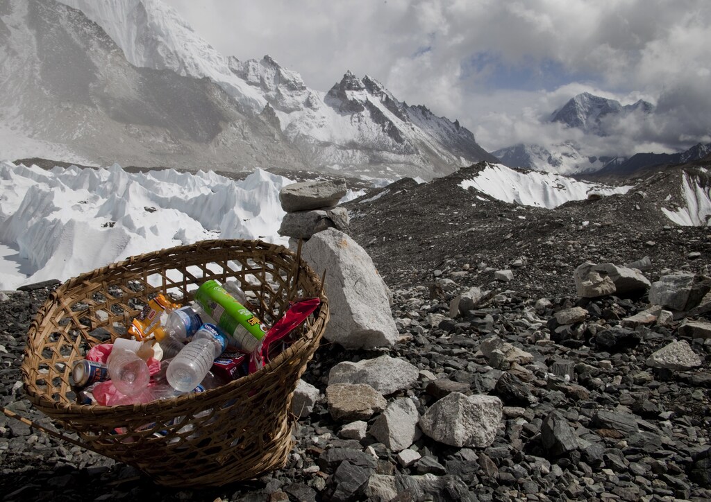 Rubbish collected at Everest base camp with the Himalayan range seen at the background in Nepal, May 03, 2011. Picture taken May 03, 2011. REUTERS/Laurence Tan (NEPAL - Tags: TRAVEL SOCIETY) - GM1E75P1OV001