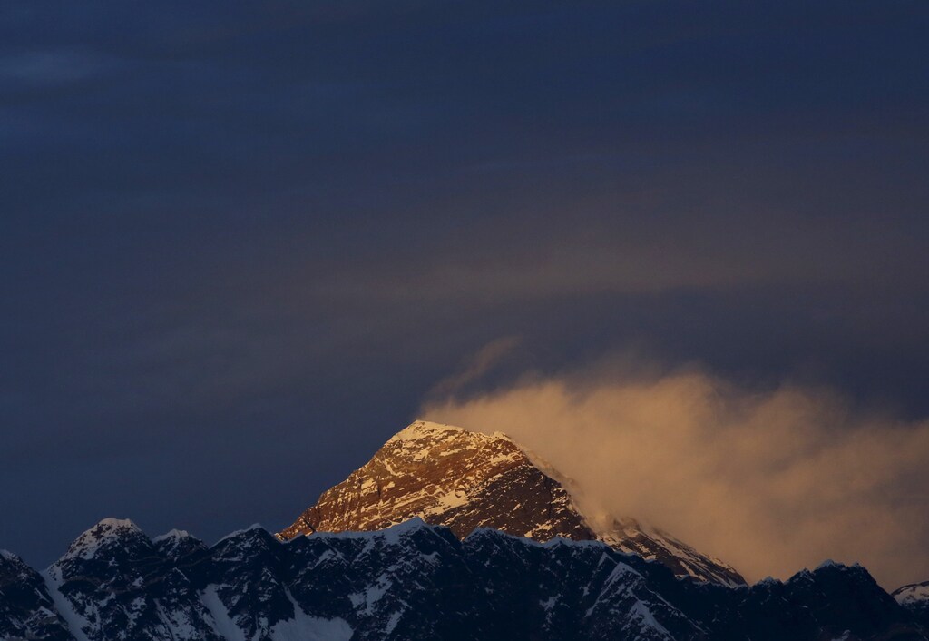 Light illuminates Mount Everest, during the in Solukhumbu District also known as the Everest region, in this picture taken November 30, 2015. To match Insight QUAKE-NEPAL/SHERPAS REUTERS/Navesh Chitrakar - GF10000266318