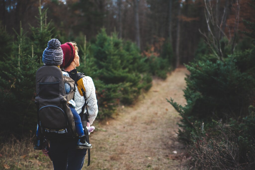 Women walking in the woods with child.