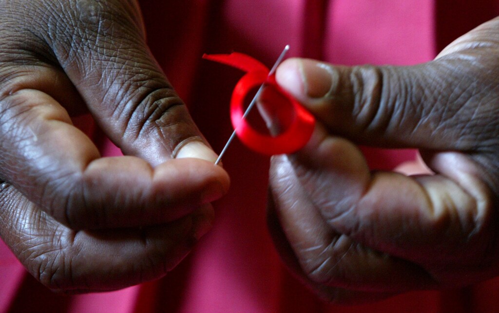 A Kenyan woman prepares ribbons ahead of December 1st, the World Aids Day at Beacon of Hope centre in Nairobi.