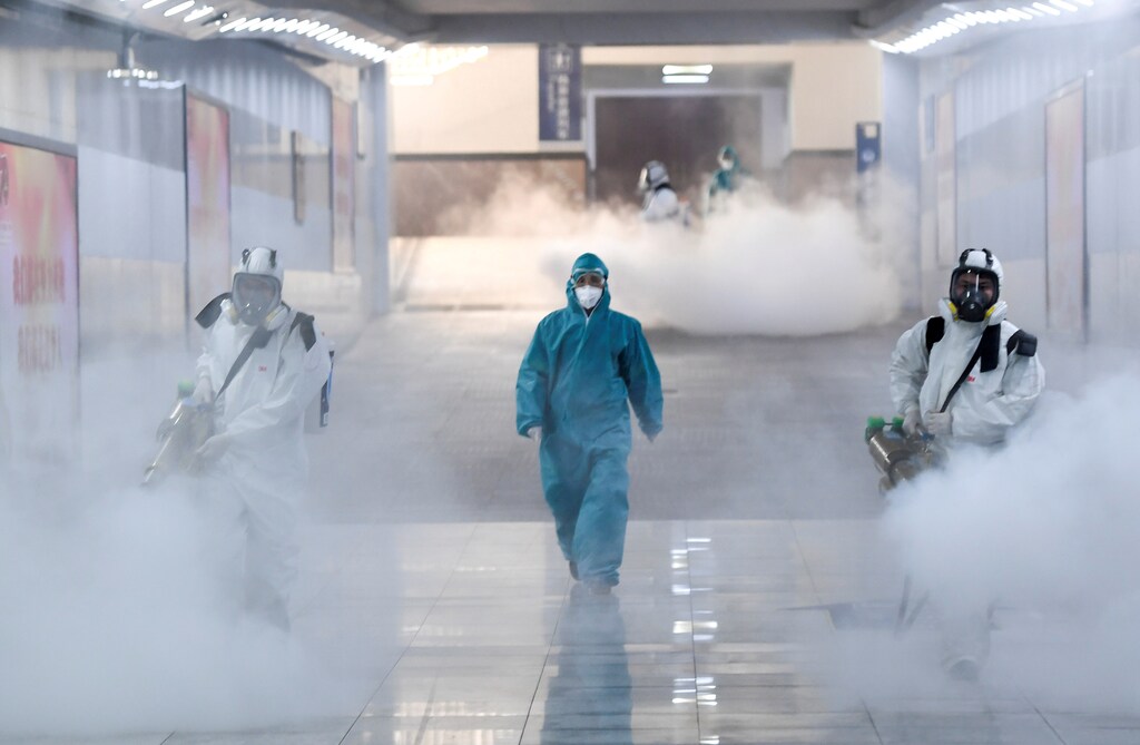 Volunteers in protective suits disinfect a railway station as the country is hit by an outbreak of the new coronavirus, in Changsha, Hunan province, China February 4, 2020.