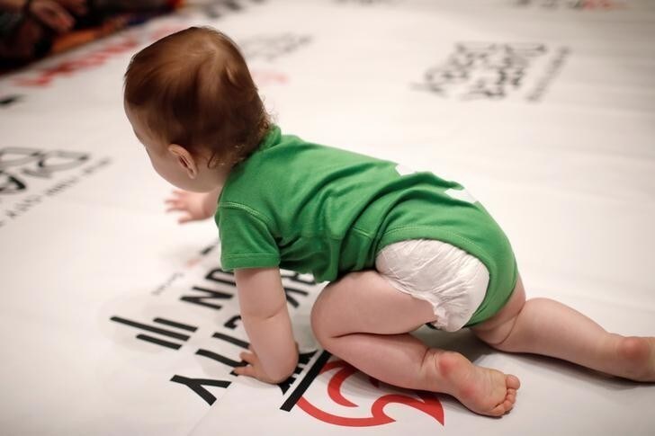 A baby competes in the 2017 "Diaper Derby" crawling race, a promotion event ahead of the New York City Triathlon in New York City, U.S., July 14, 2017. REUTERS/Mike Segar