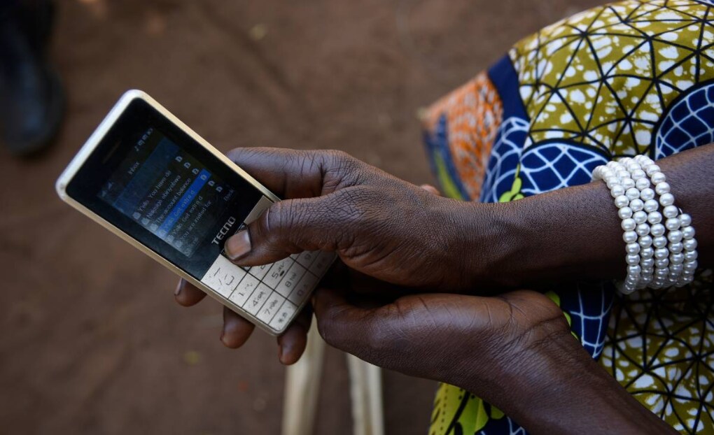 sther Nakisige, a beneficiary of the MUIIS farmer information service, checks her phone at her home in Iganga District, Uganda, on February 14, 2019. Thomson Reuters Foundation/Stringer