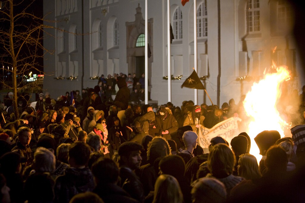 Protesters surround a bonfire lit by demonstrators in front of the National Theater in downtown Reykjavik January 21, 2009. Crisis-hit Iceland's Prime Minister Geir Haarde said on Wednesday the government's coalition partners would continue cooperating as protesters gathered in front of parliament for a second straight day. REUTERS via Your View/Ingolfur Juliusson