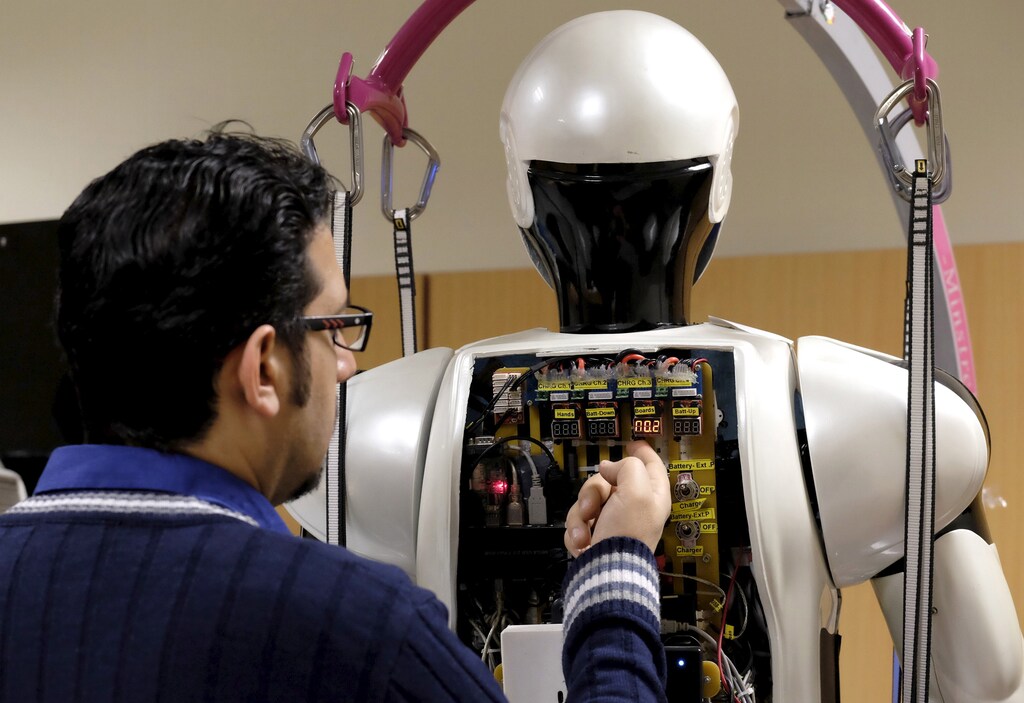 An engineer works on Surena 3 humanoid robot in a lab at Tehran University, Iran December 6, 2015. The University of Tehran has developed a humanoid robot that weighs 98 kg. It can navigate uneven terrain and detect faces. REUTERS/Raheb Homavandi/TIMA ATTENTION EDITORS - THIS IMAGE WAS PROVIDED BY A THIRD PARTY. FOR EDITORIAL USE ONLY. - GF10000256818