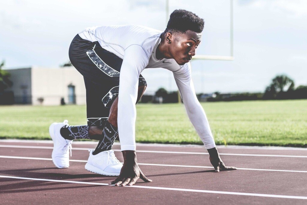 An athlete in starting position on a track
