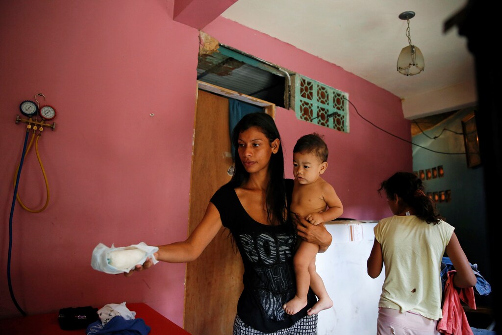 Geraldine Rocca, 29, carries her son Jeremy, ahead of her sterilization surgery in Caracas, Venezuela July 20, 2016. REUTERS/Carlos Garcia Rawlins SEARCH "STERILIZATION CHILD" FOR THIS STORY. SEARCH "THE WIDER IMAGE" FOR ALL STORIES. - RTSKV3G