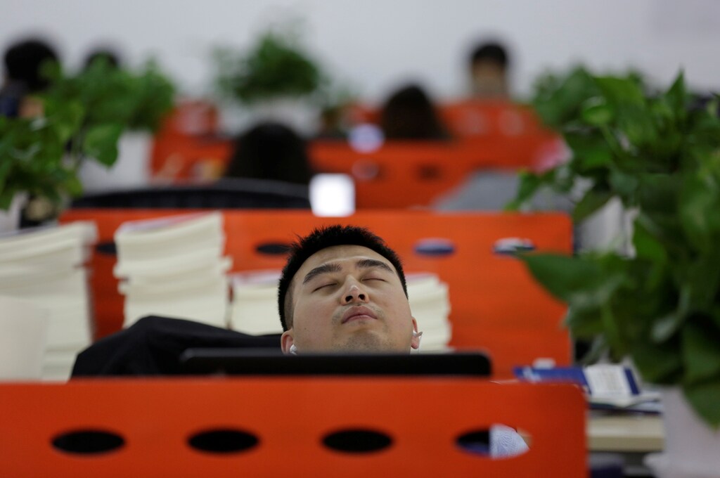 Cui Meng, a Co-founder of Goopal Group, takes a nap in his seat after lunch, in Beijing, China, April 21, 2016. Office workers sleeping on the job is a common sight in China, where a surplus of cheap labour can lead to downtime at work. But in China's technology sector, where business is growing faster than many start-up firms can hire new staff, workers burn the midnight oil to meet deadlines and compete with their rivals. Some companies provide sleeping areas and beds for workers to rest during late nights. REUTERS/Jason Lee SEARCH "JASON SLEEP" FOR THIS STORY. SEARCH "THE WIDER IMAGE" FOR ALL STORIES - S1BETDIDHOAD