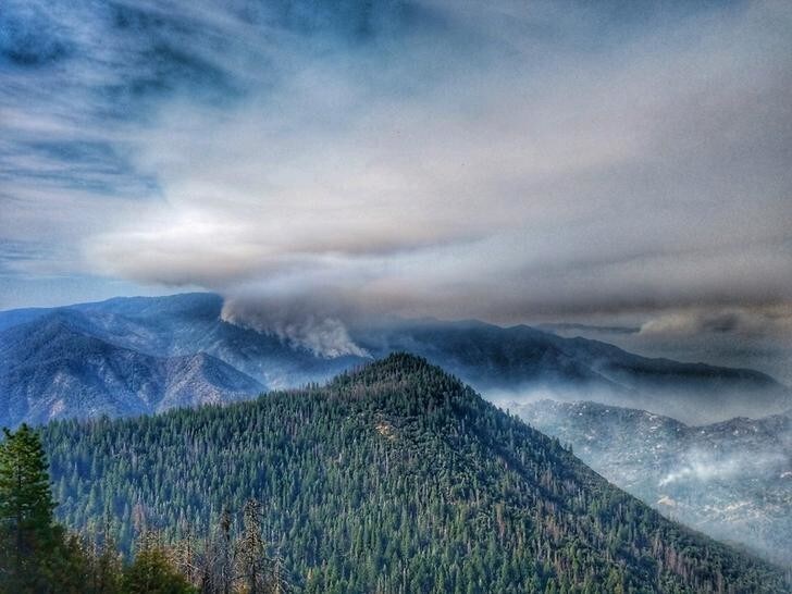 FILE PHOTO: Smoke rises near Pinoche Peak on the east flank of the Ferguson Fire looking towards Chowchilla Mountain in this Yosemite Fire and Aviation photo from California, U.S. released on social media on July 23, 2018. Courtesy Yosemite Fire and Aviation/USDA/US Forest Service/Handout via REUTERS ATTENTION EDITORS - THIS IMAGE HAS BEEN SUPPLIED BY A THIRD PARTY.REUTERS/ /File Photo