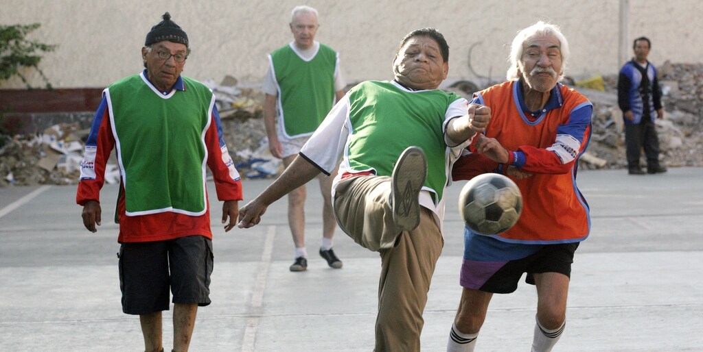 Elderly people play soccer at the yard of the Canevaro old people's home in Lima March 24, 2010. This public institution is one the biggest in its kind in Latin America, hosting almost 400 elderly people, including dependent patients and those with senile dementia. 90 percent of its population are in abandon condition and more than the half used to live in extreme poverty, according to Canevaro's Director, Felipe Aguirre. Picture taken March 24, 2010. REUTERS/Enrique Castro-Mendivil (PERU - Tags: HEALTH SOCIETY SPORT SOCCER) - RTR2C3AA